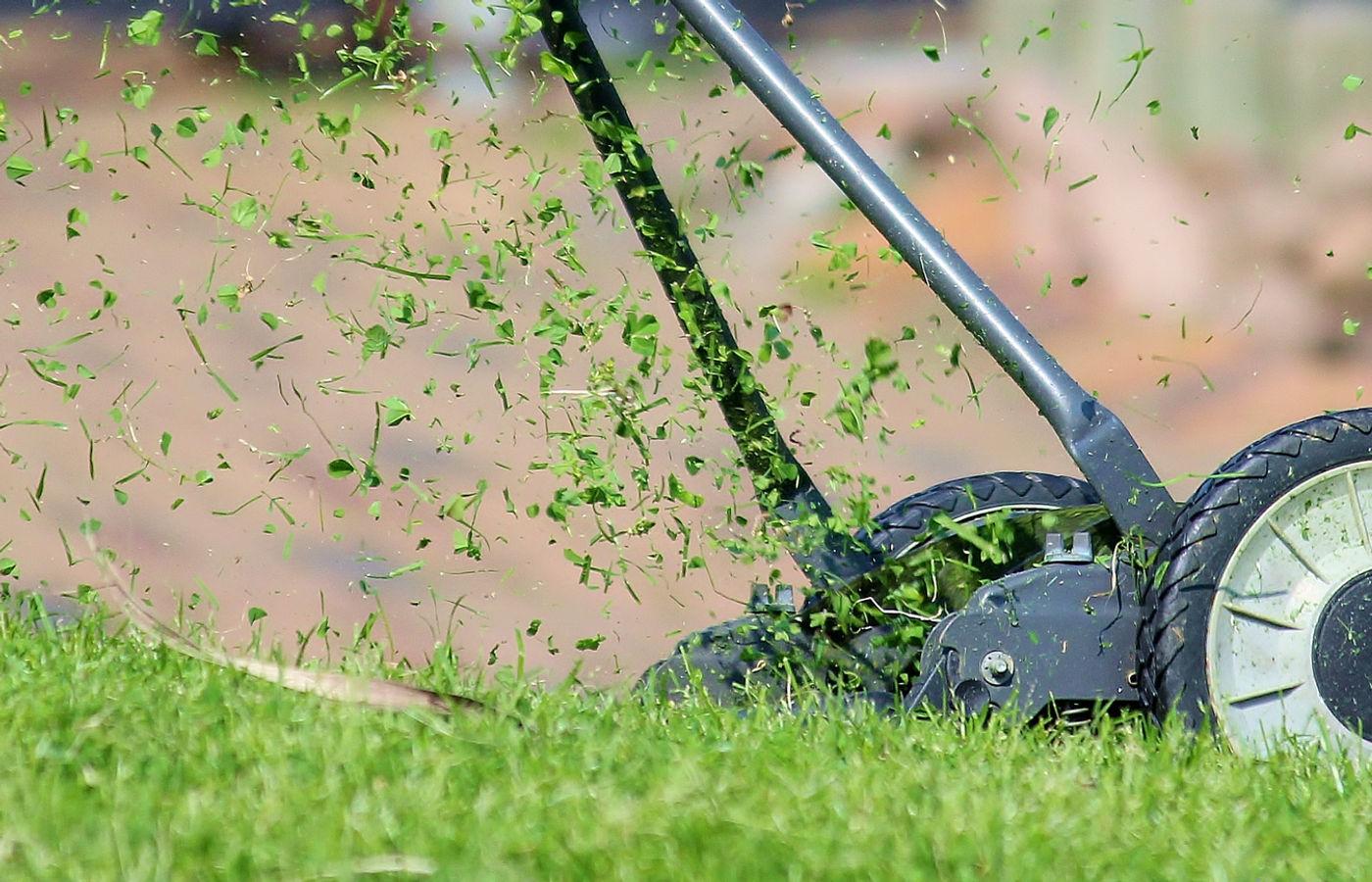 Mower at work cutting a home lawn